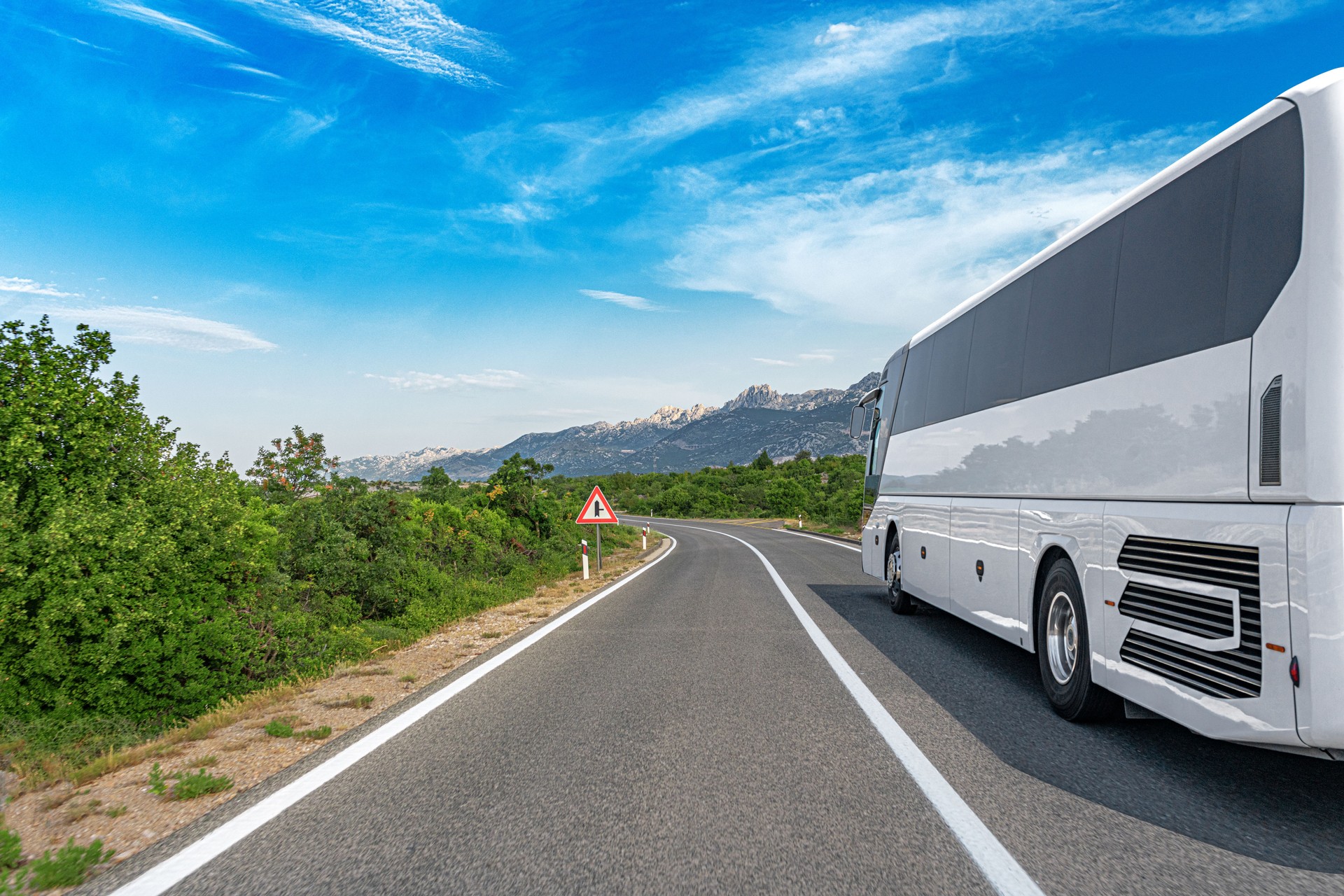 Passenger bus on the highway against the backdrop of a beautiful landscape.