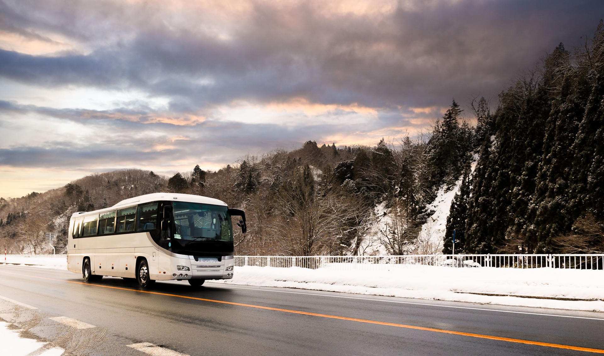 Tour bus traveling along a snowy road